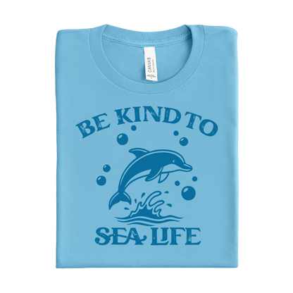 Folded ocean blue t-shirt with a dolphin graphic and text on a white background