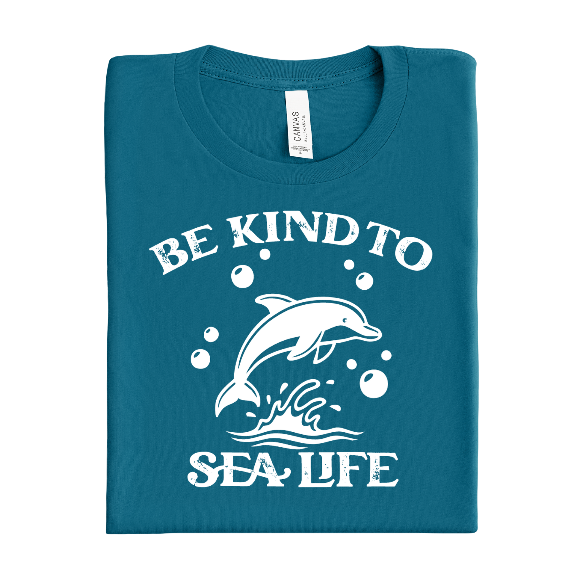 Folded deep teal t-shirt with white dolphin graphic and text 'Be Kind to Sea Life' on a white background