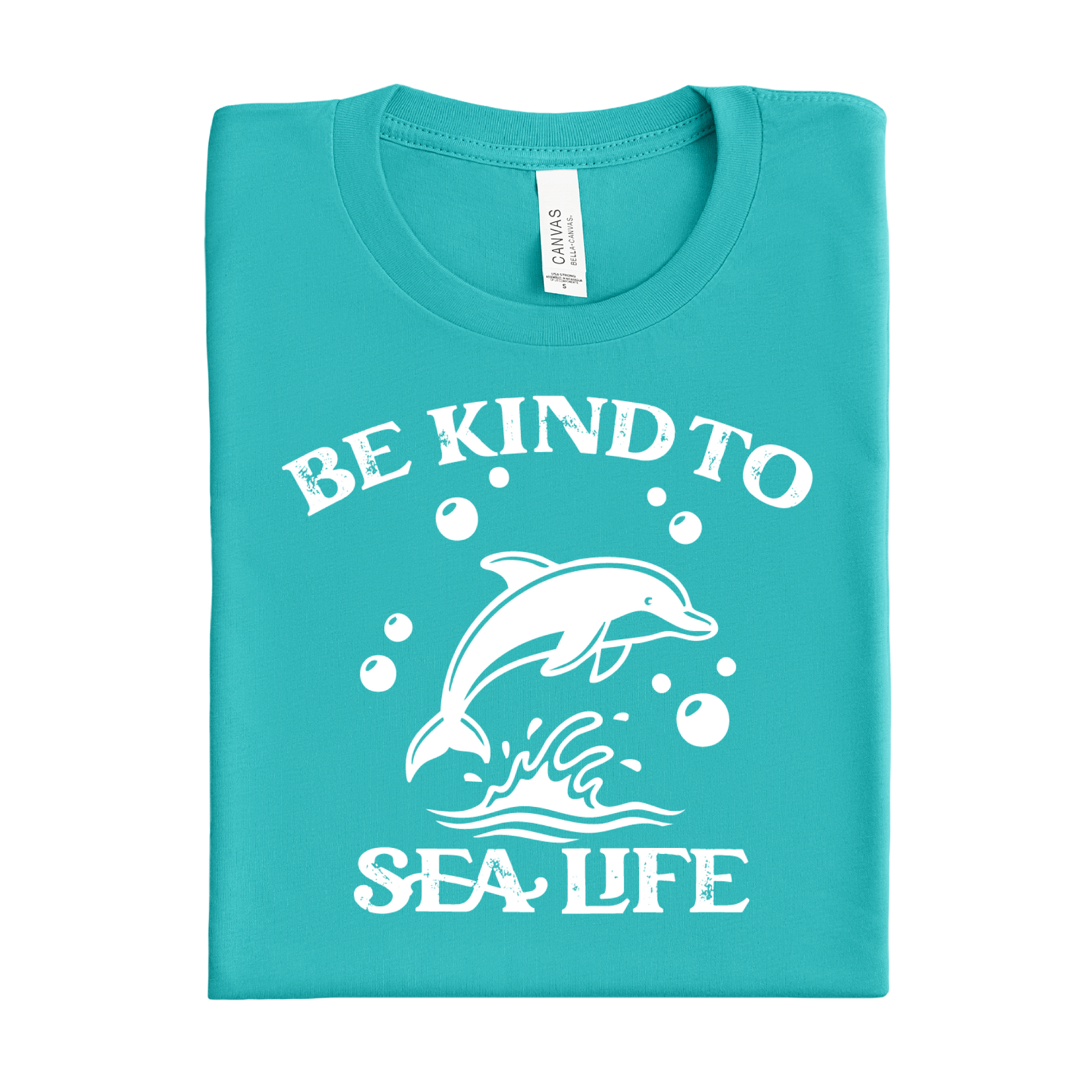 Folded teal t-shirt with white dolphin graphic and text 'Be Kind to Sea Life' on a white background