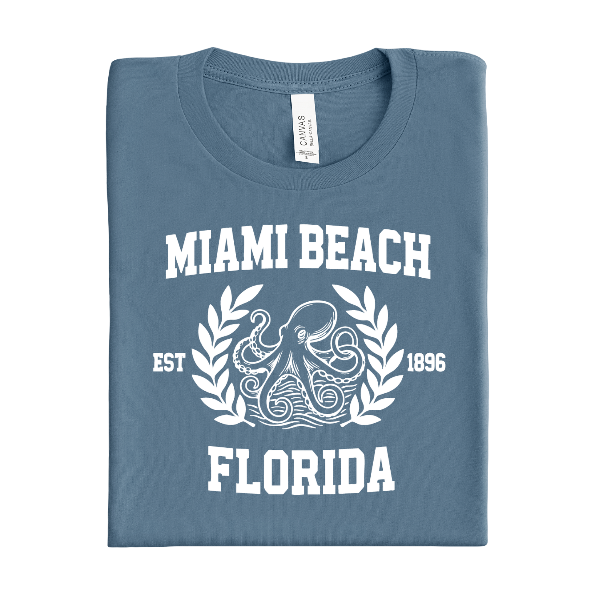 Folded steel blue t-shirt with 'Miami Beach Florida' text and octopus design on a white background
