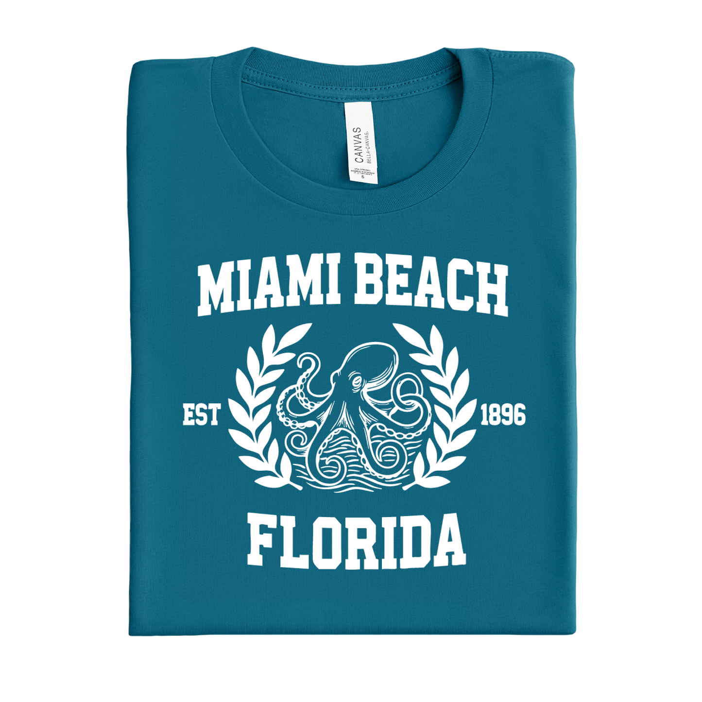 Folded deep teal t-shirt with 'Miami Beach, Florida' text and octopus design on a white background