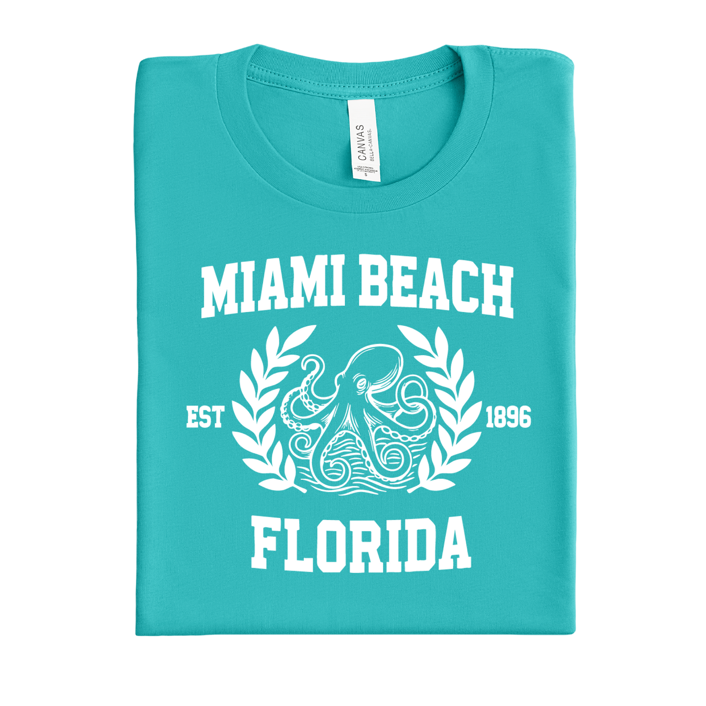Folded teal t-shirt with 'Miami Beach, Florida' text and octopus design on a white background