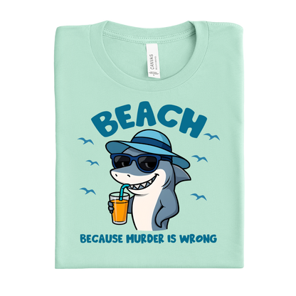 Mint green t-shirt with a shark graphic and text on a white background