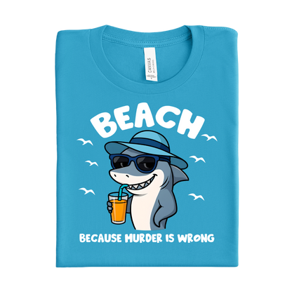 Folded aqua blue t-shirt with a shark graphic and text on a white background