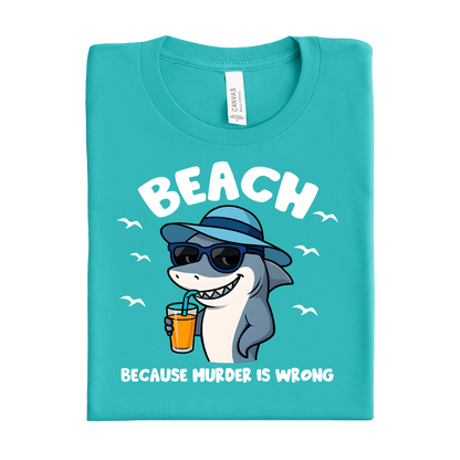 Folded teal t-shirt with a shark graphic and text on a white background