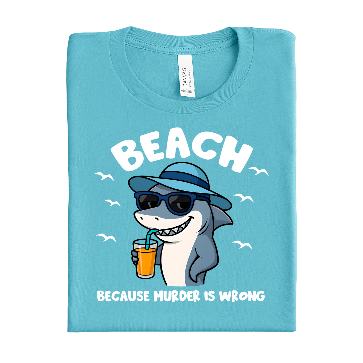 Folded turquoise t-shirt with a shark graphic and text on a white background