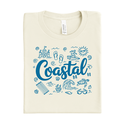 Folded natural colored t-shirt with blue coastal-themed graphics and text on a white background