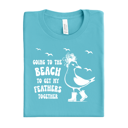 Folded Turquoise t-shirt with a white bird graphic and text on a white background