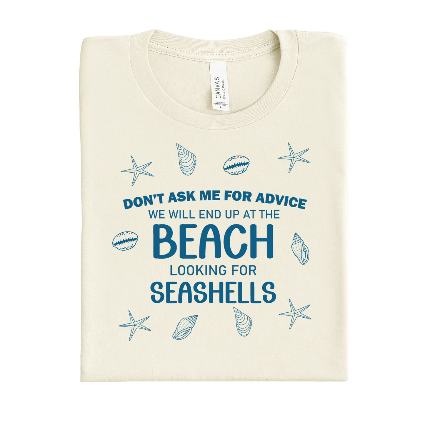 Folded t-shirt with beach-themed text and graphics on a white background