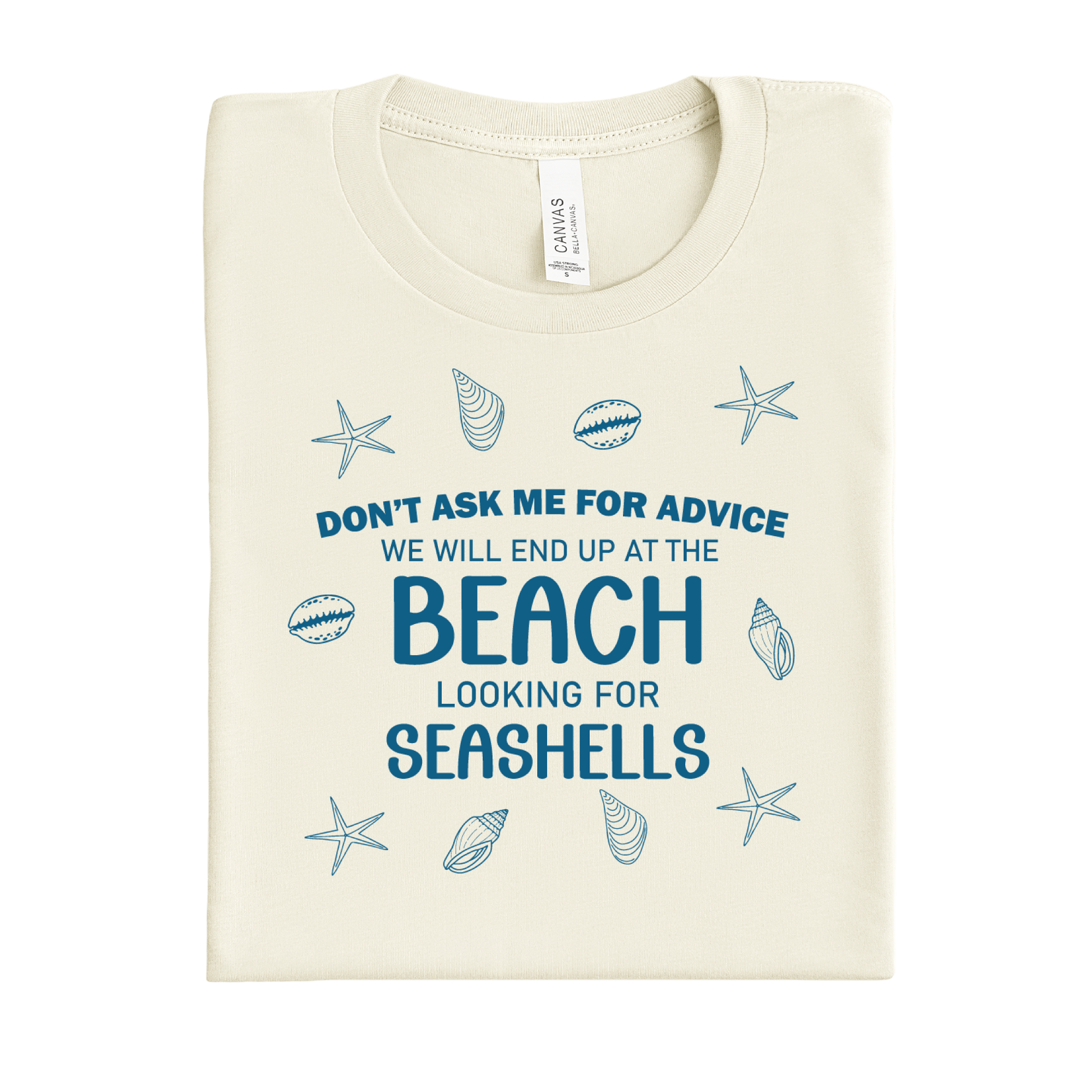 Folded t-shirt with beach-themed text and graphics on a white background
