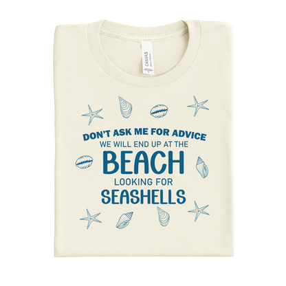 Folded t-shirt with beach-themed text and graphics on a white background