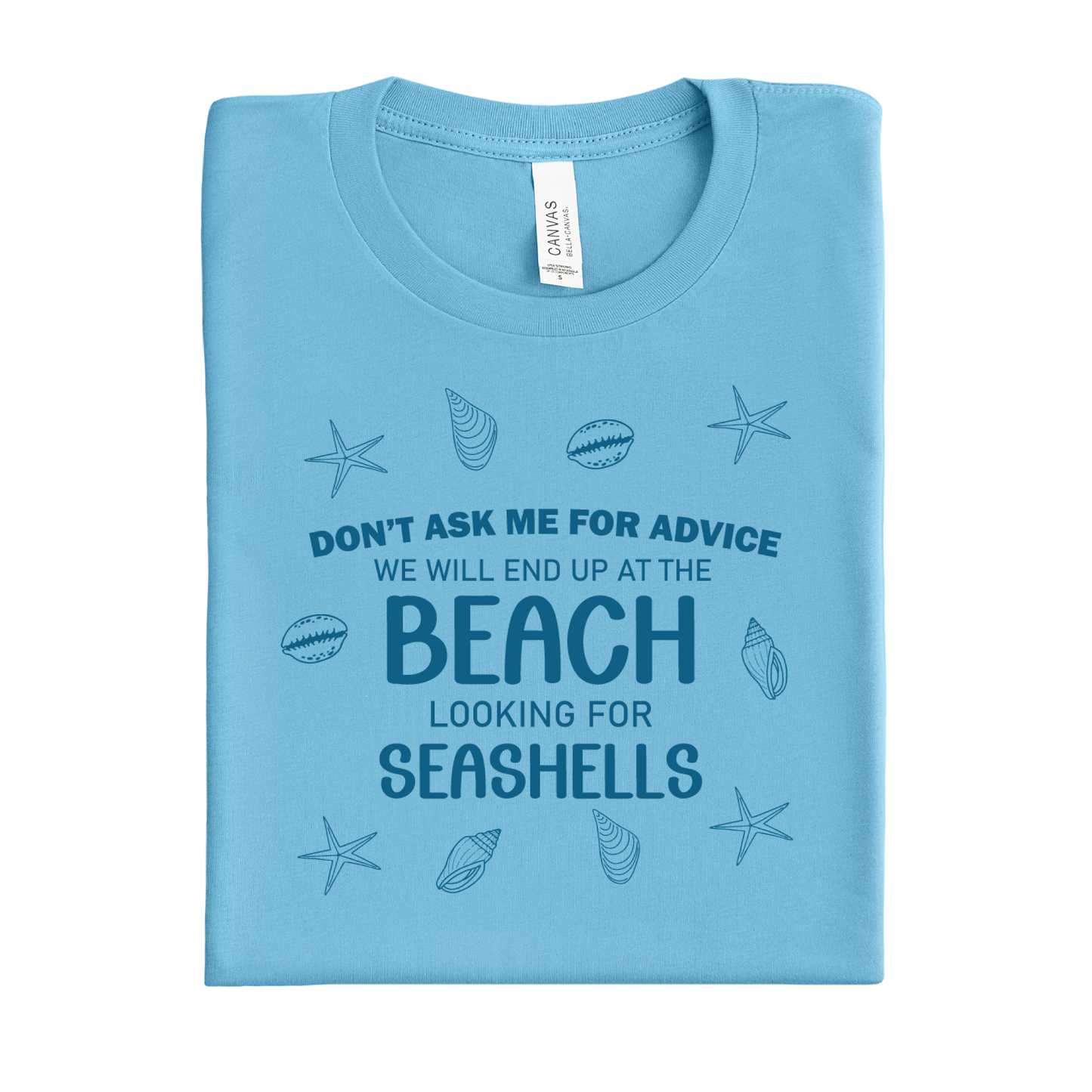 Folded ocean blue t-shirt with beach-themed text and graphics on a white background