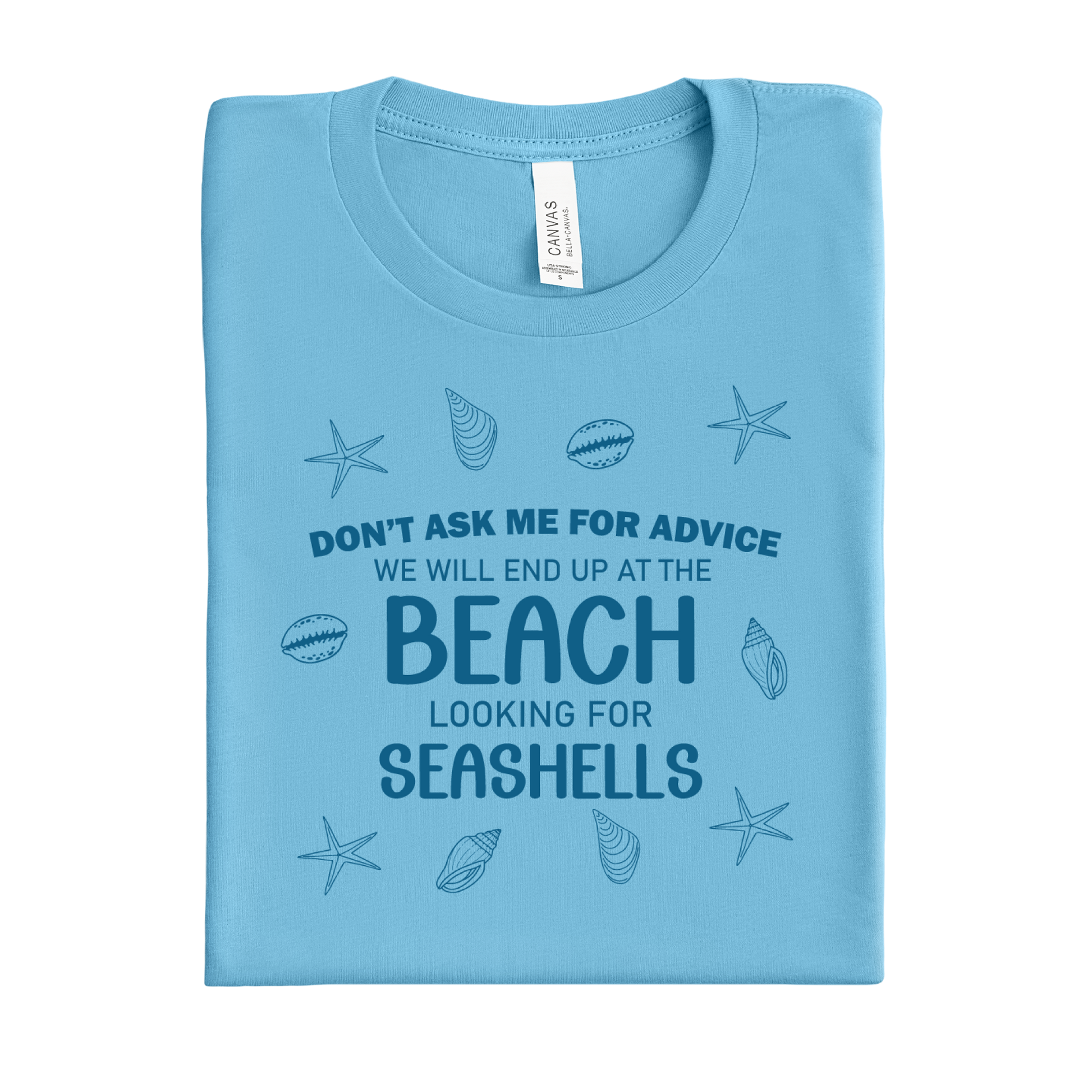 Folded ocean blue t-shirt with beach-themed text and graphics on a white background