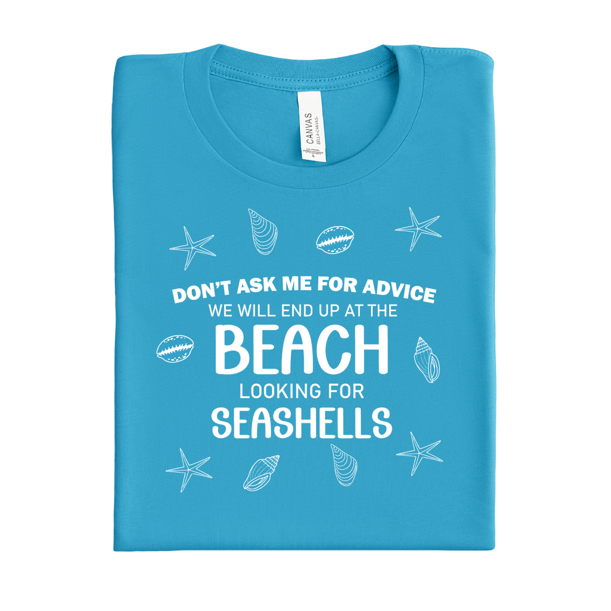 Folded aqua blue t-shirt with beach-themed text and graphics on a white background