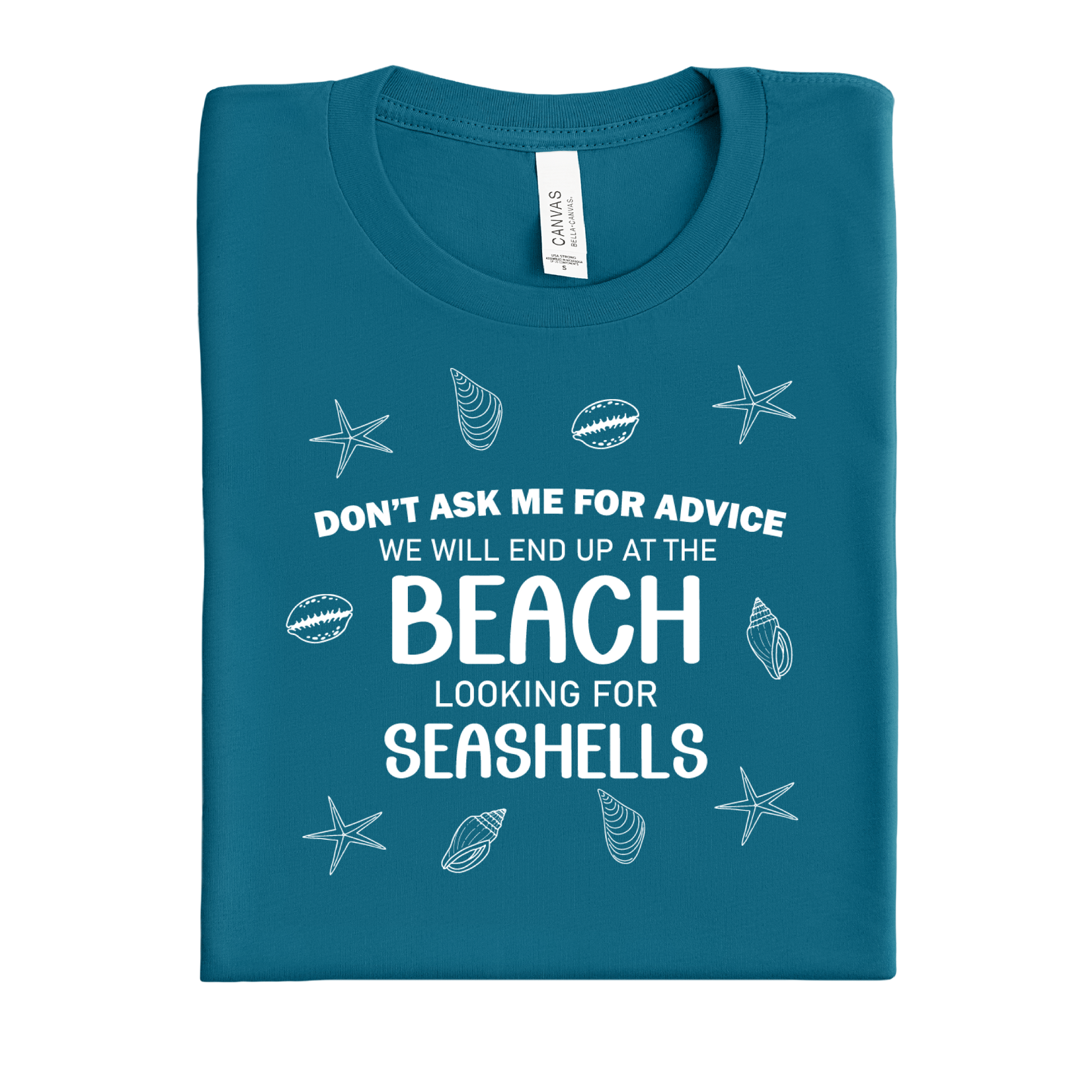 Folded deep teal t-shirt with beach-themed text and graphics on a white background
