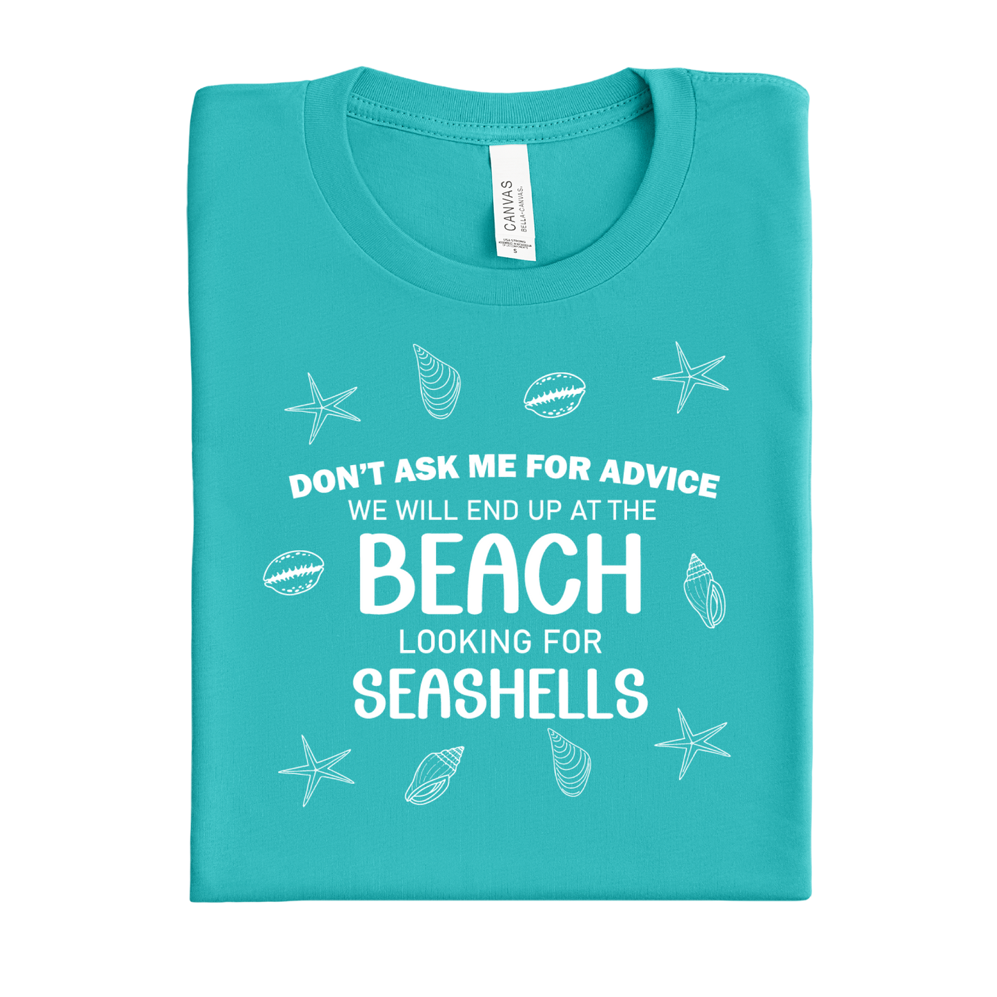 Folded teal t-shirt with beach-themed text and graphics on a white background