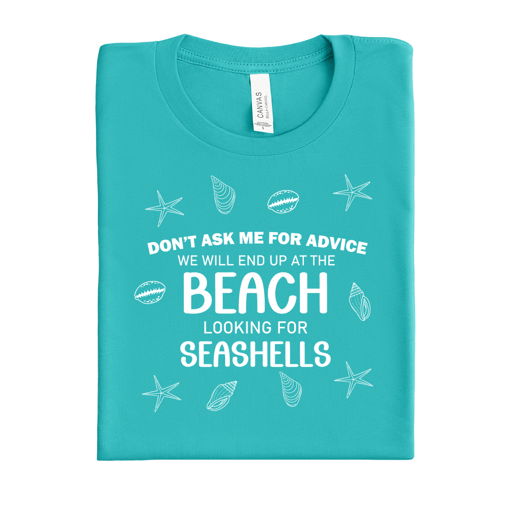 Folded teal t-shirt with beach-themed text and graphics on a white background
