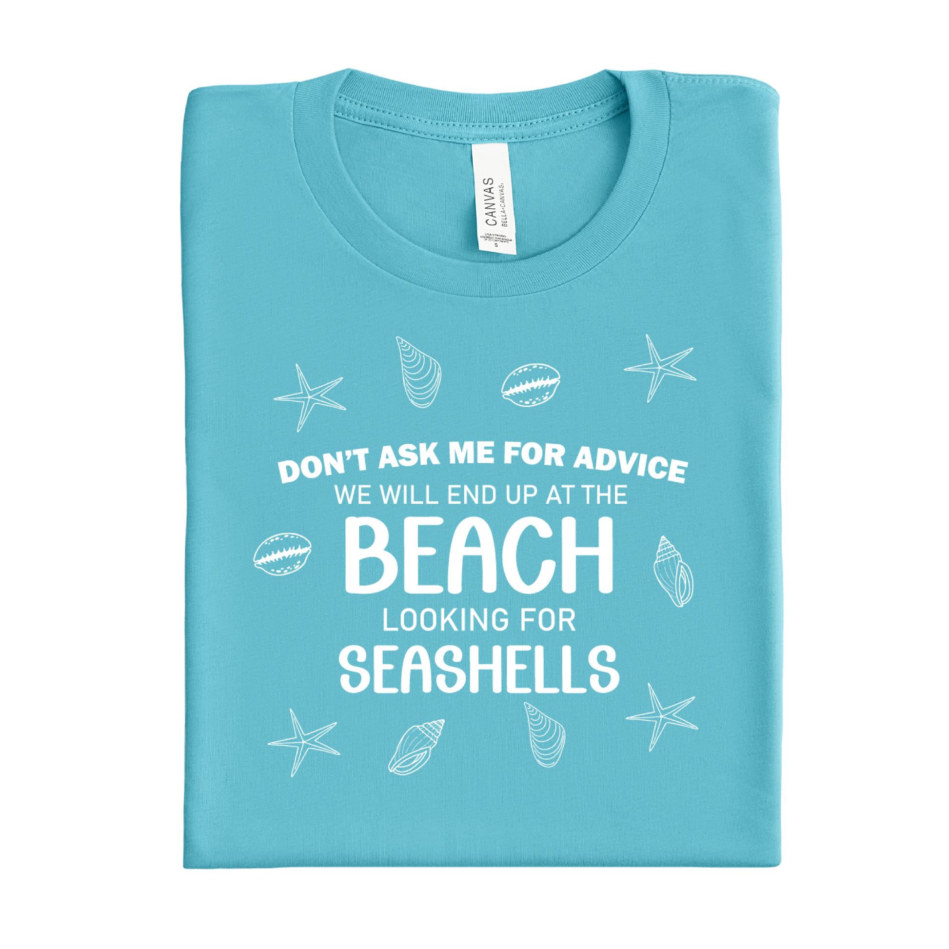 Folded turquoise t-shirt with beach-themed text and graphics on a white background