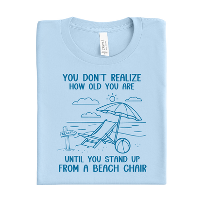 Baby blue t-shirt with beach graphic and text on a white background