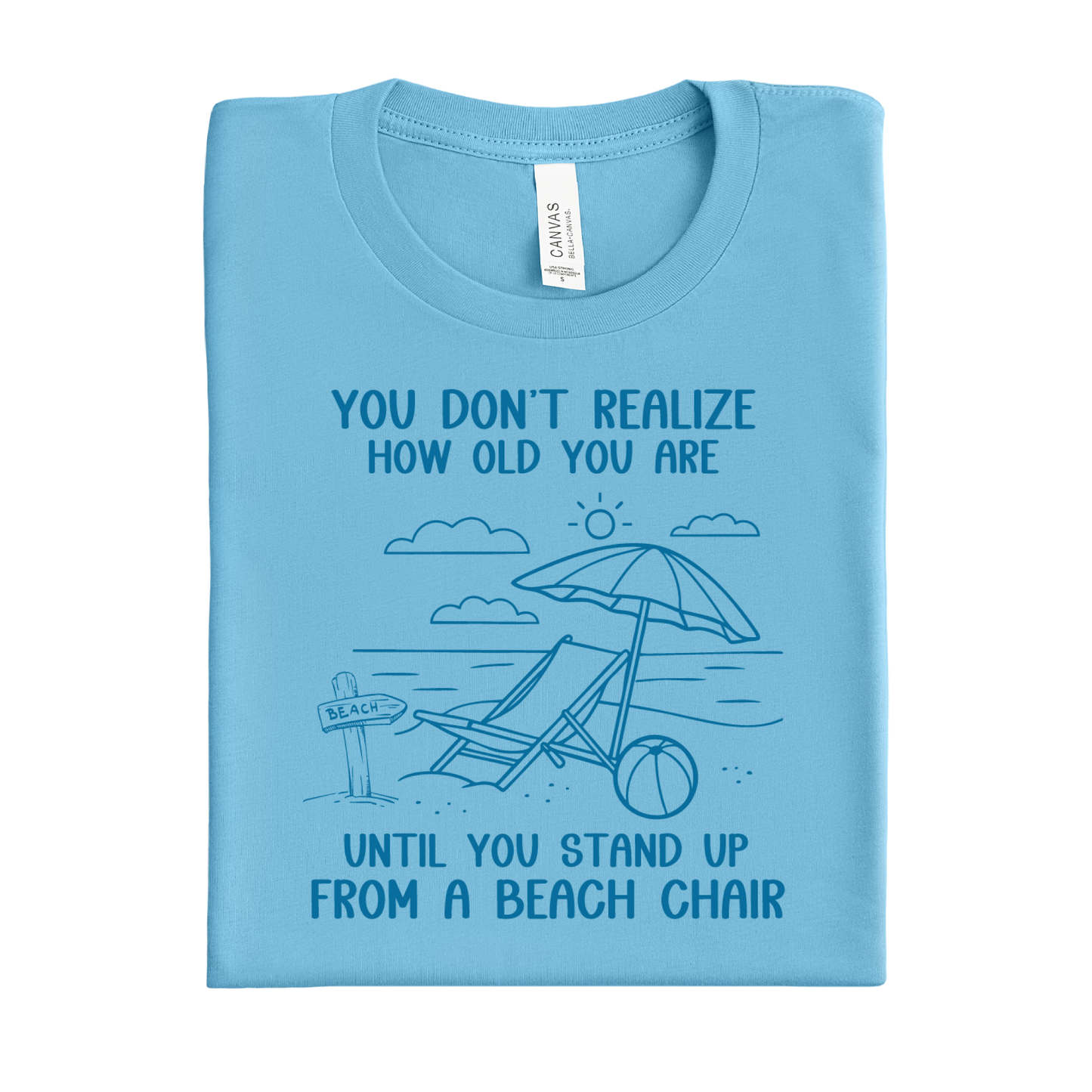 Folded ocean blue t-shirt with beach graphic and text on a white background