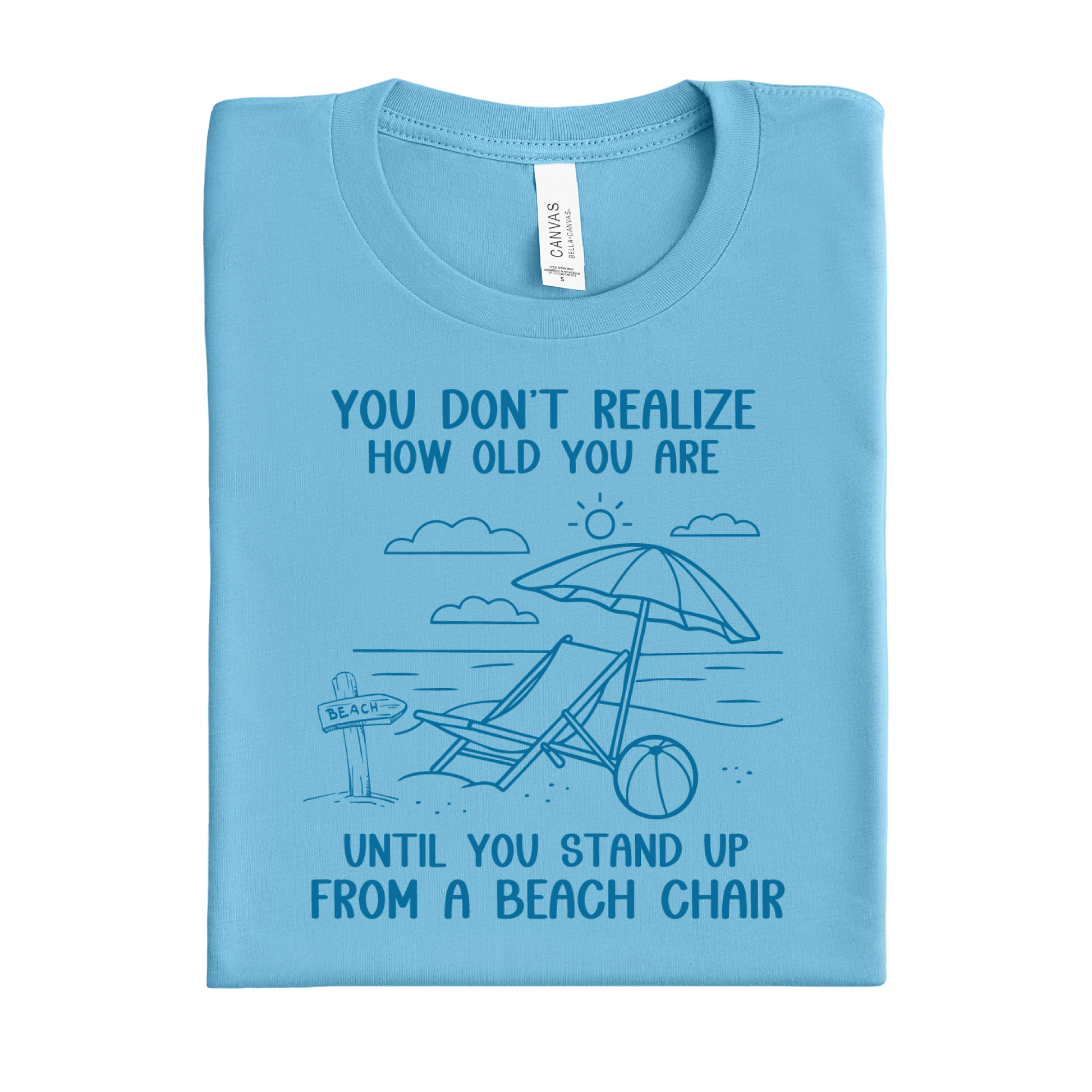 Folded ocean blue t-shirt with beach graphic and text on a white background