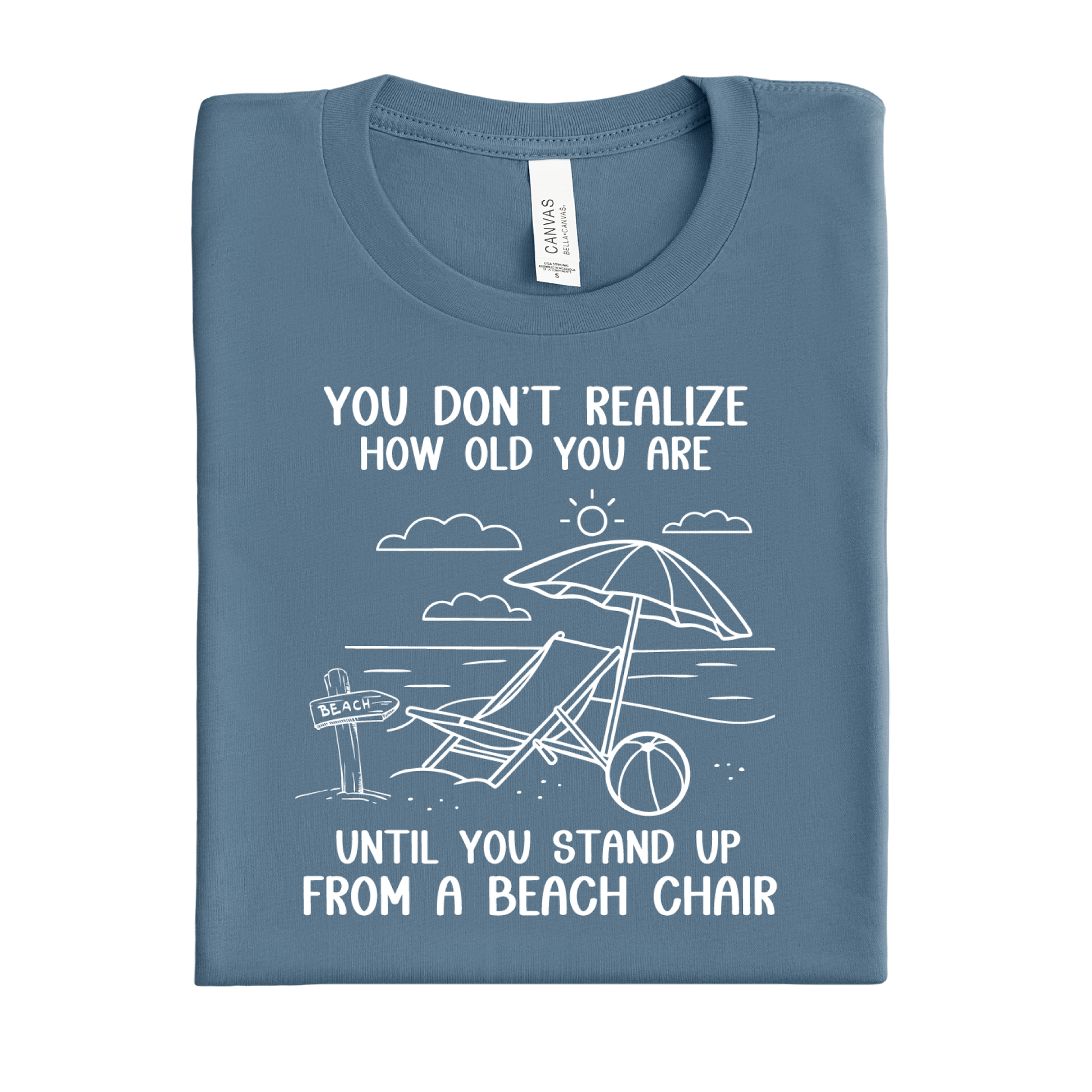 Folded blue steel t-shirt with beach graphic and text on a white background