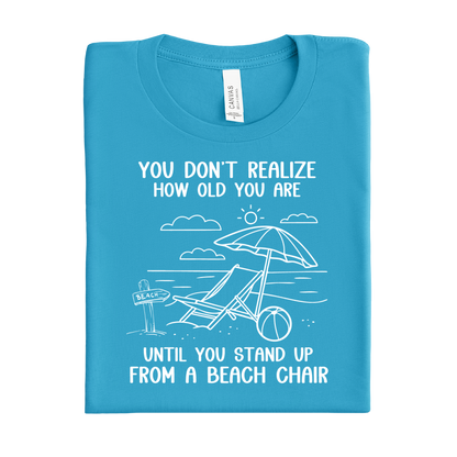 Aqua Blue t-shirt with beach-themed design and text on a white background