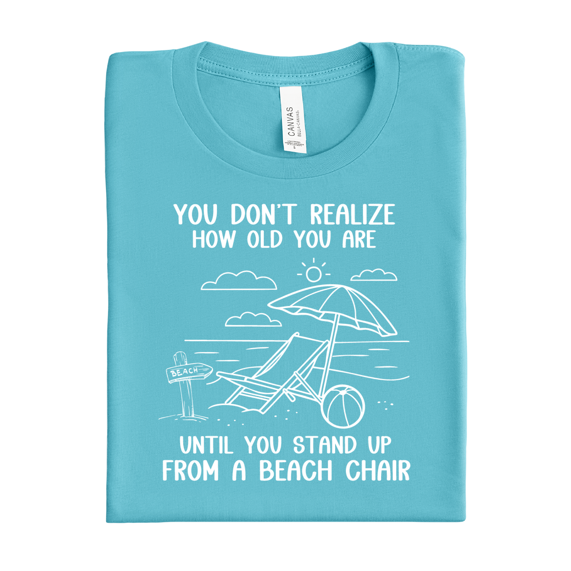 Folded turquoise t-shirt with beach graphic and text on a white background