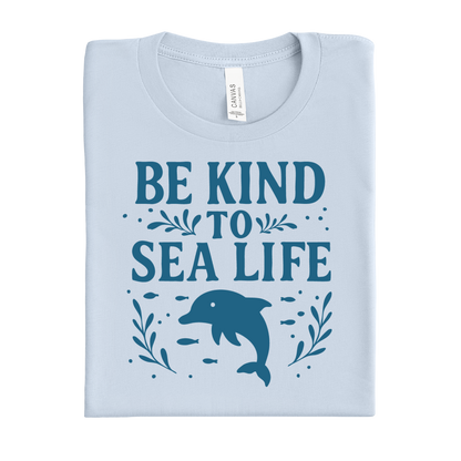 Light blue t-shirt with 'Be Kind to Sea Life' text and dolphin graphic on a white background