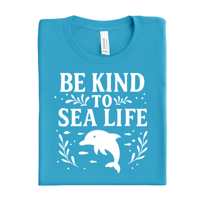 Aqua Blue t-shirt with 'Be Kind to Sea Life' text and dolphin graphic on a white background