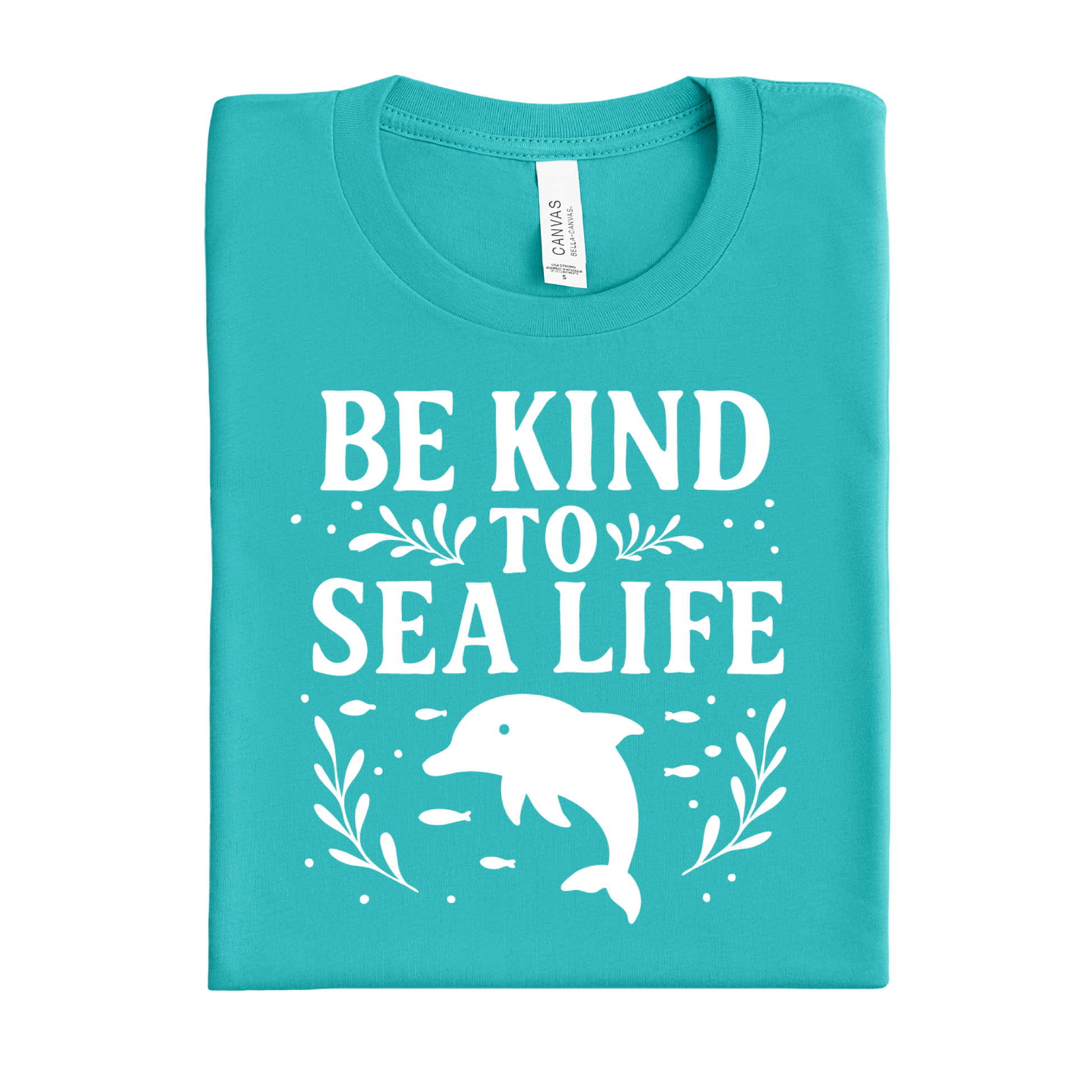 Folded teal t-shirt with 'Be Kind to Sea Life' text and dolphin graphic on a white background