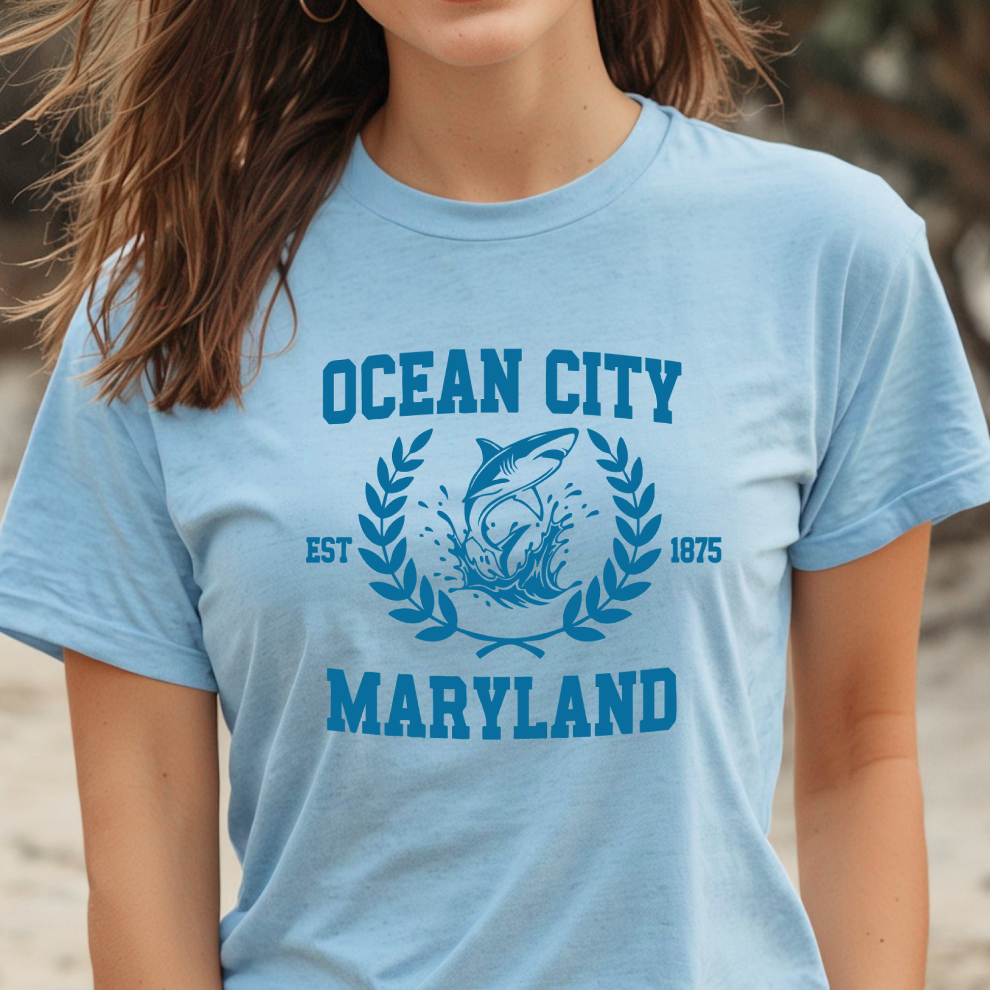 Person wearing a light blue t-shirt with 'Ocean City, Maryland' printed on it.
