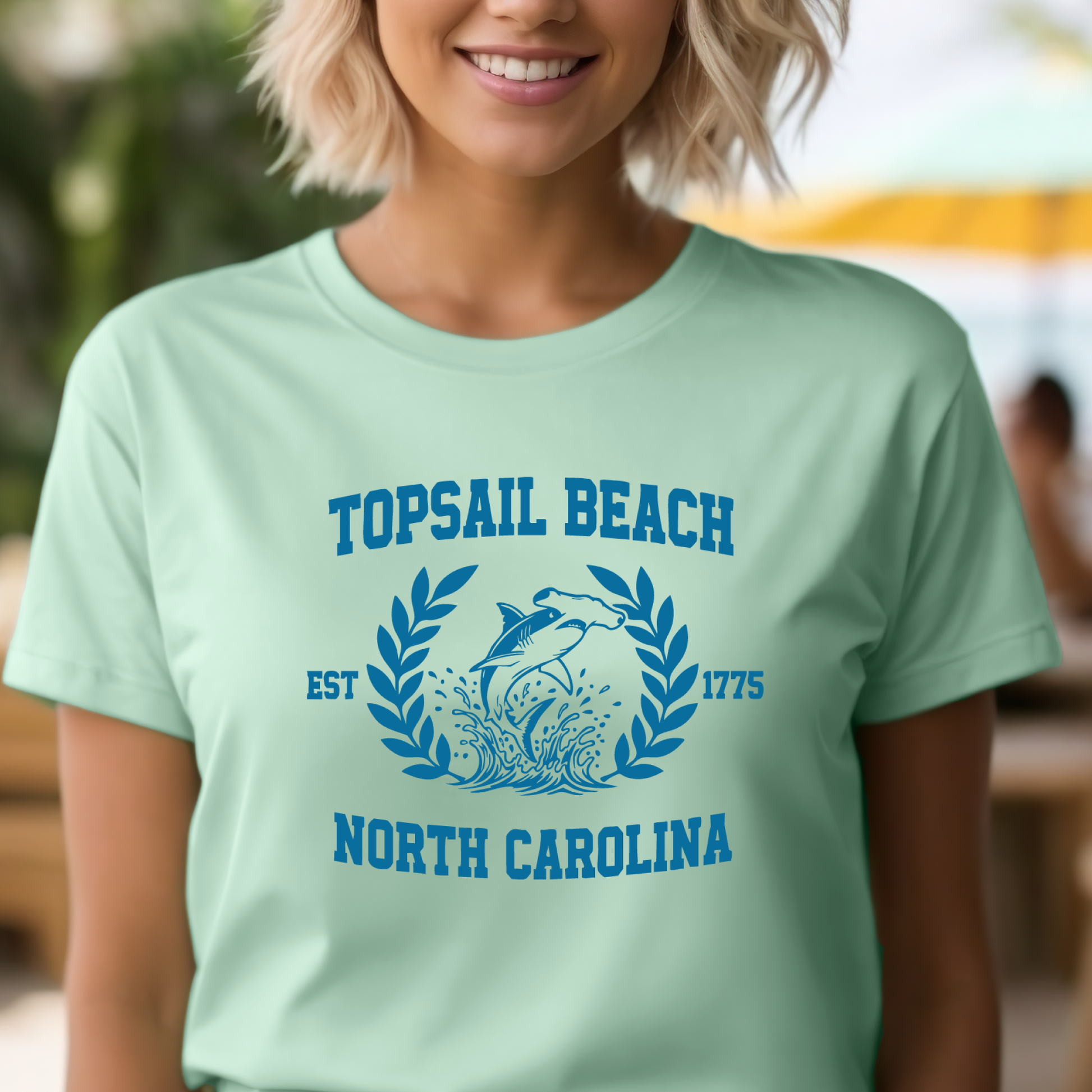 Person wearing a light green t-shirt with 'TopSail Beach, North Carolina' design.