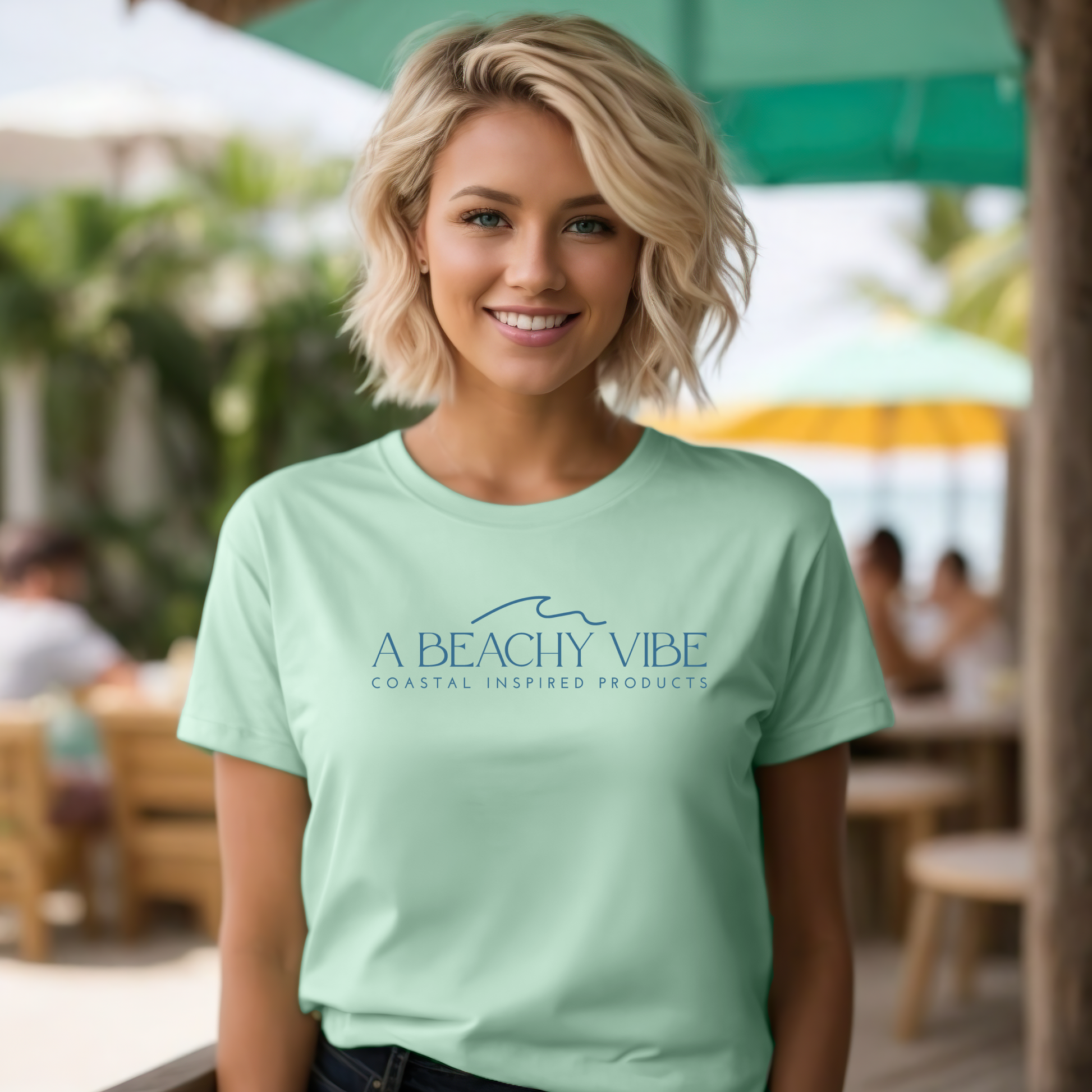 Bella Canvas 3001 "A Beachy Vibe" t shirt with a simple wave graphic with text and one color graphic. Picture of a girl on the beach in a t shirt.