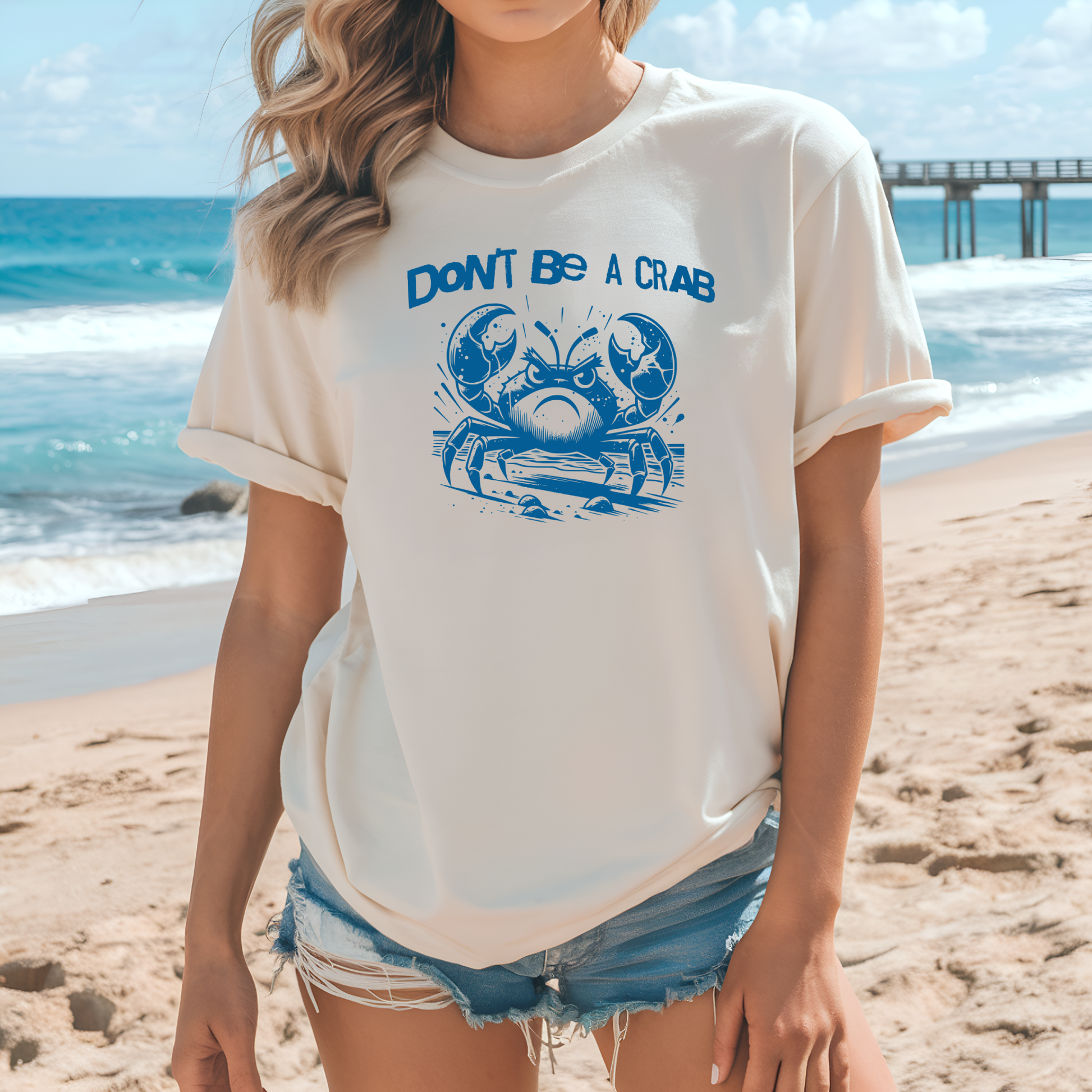 Bella Canvas 3001 "Don't Be A Crab" t shirt with cute angry crab in one color graphic. Picture of a girl standing on the beach wearing a t shirt.