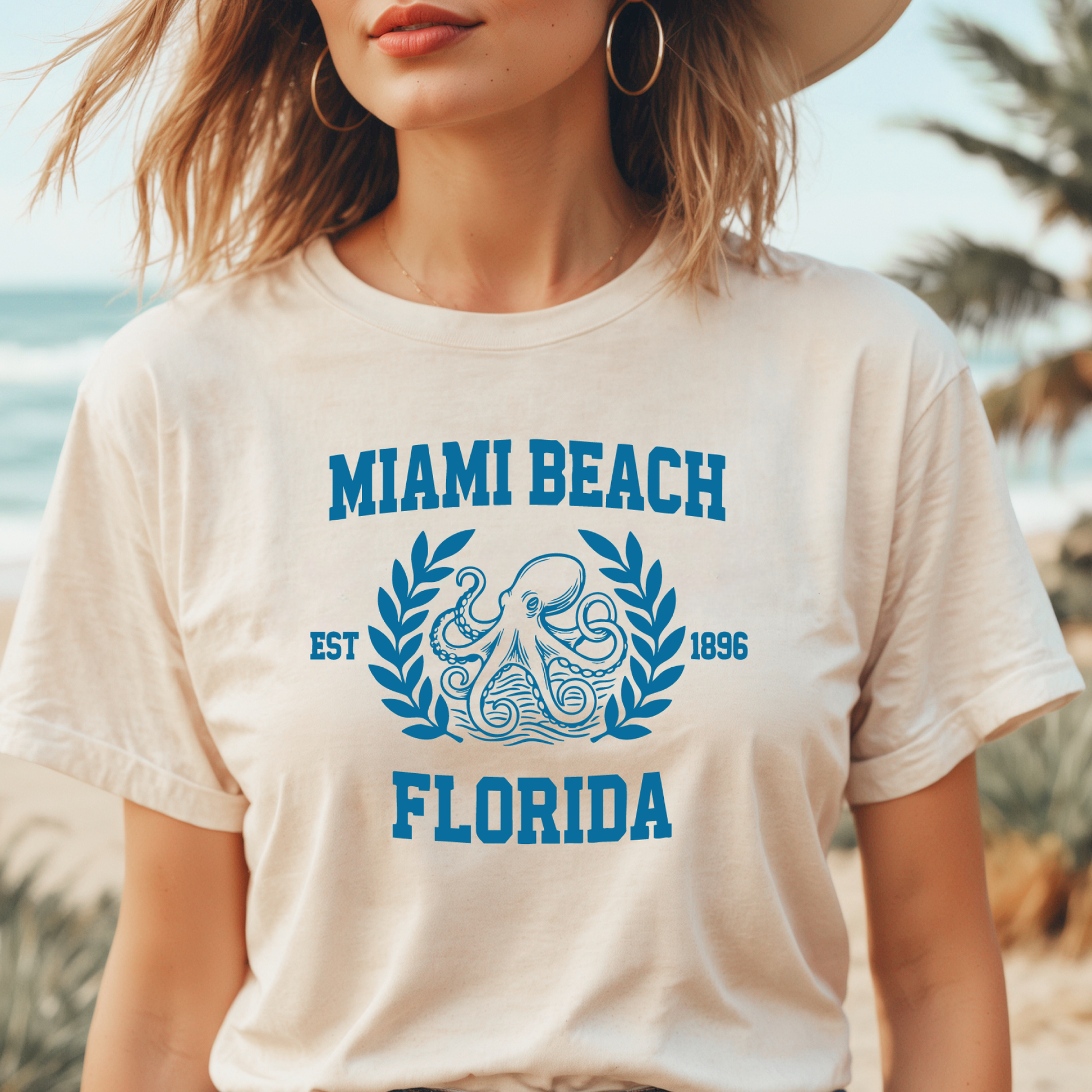Person wearing a 'Miami Beach Florida' t-shirt with a beach background