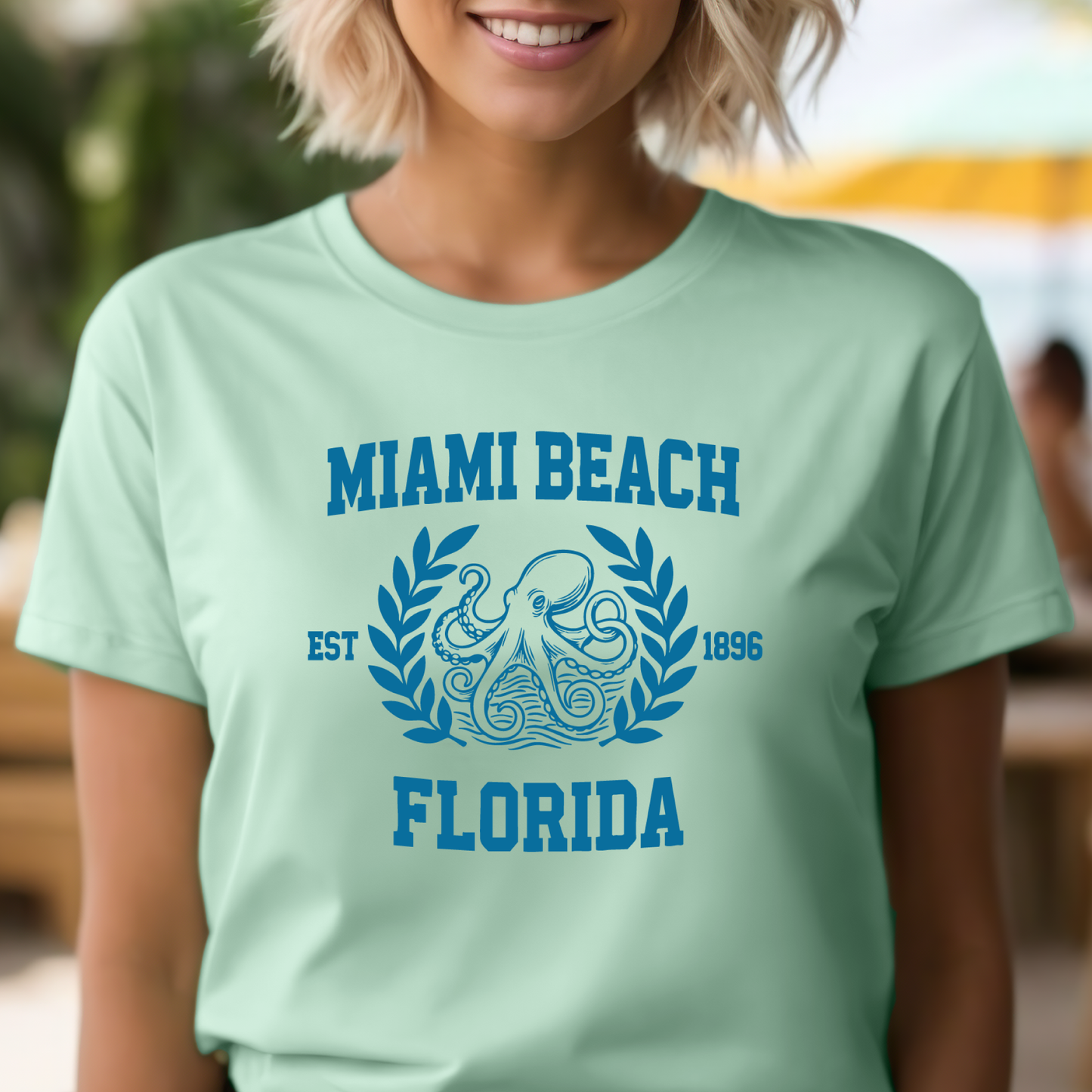 Person wearing a light green t-shirt with 'Miami Beach Florida' design.