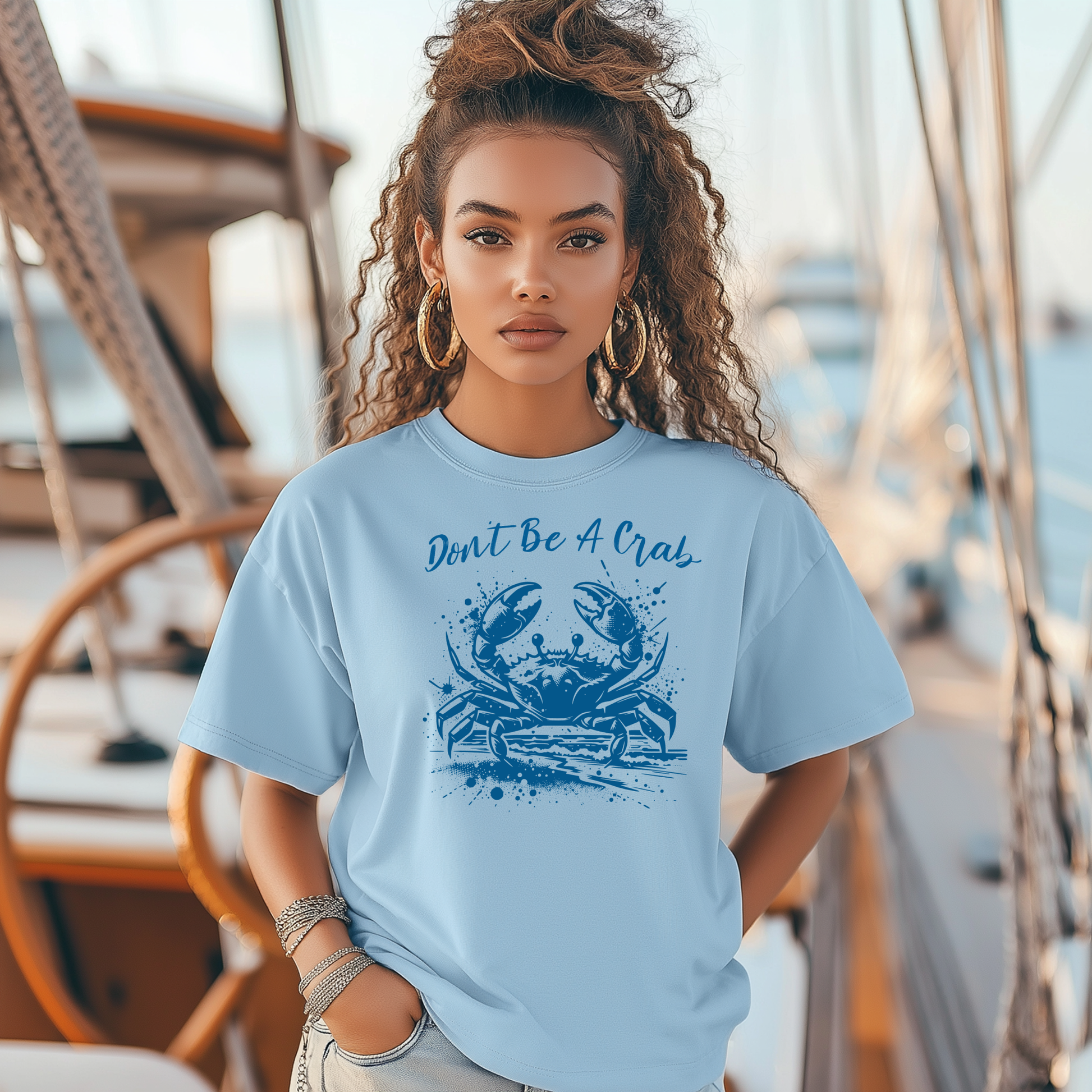 Bella and Canvas 3001 "Don't Be A Crab" t shirt with crab splashing in water one color graphic. Picture of a girl standing on a boat wearing a t shirt.