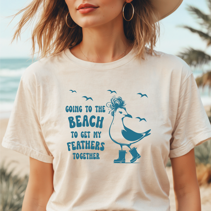Person wearing a t-shirt with a beach-themed design featuring a bird and text.