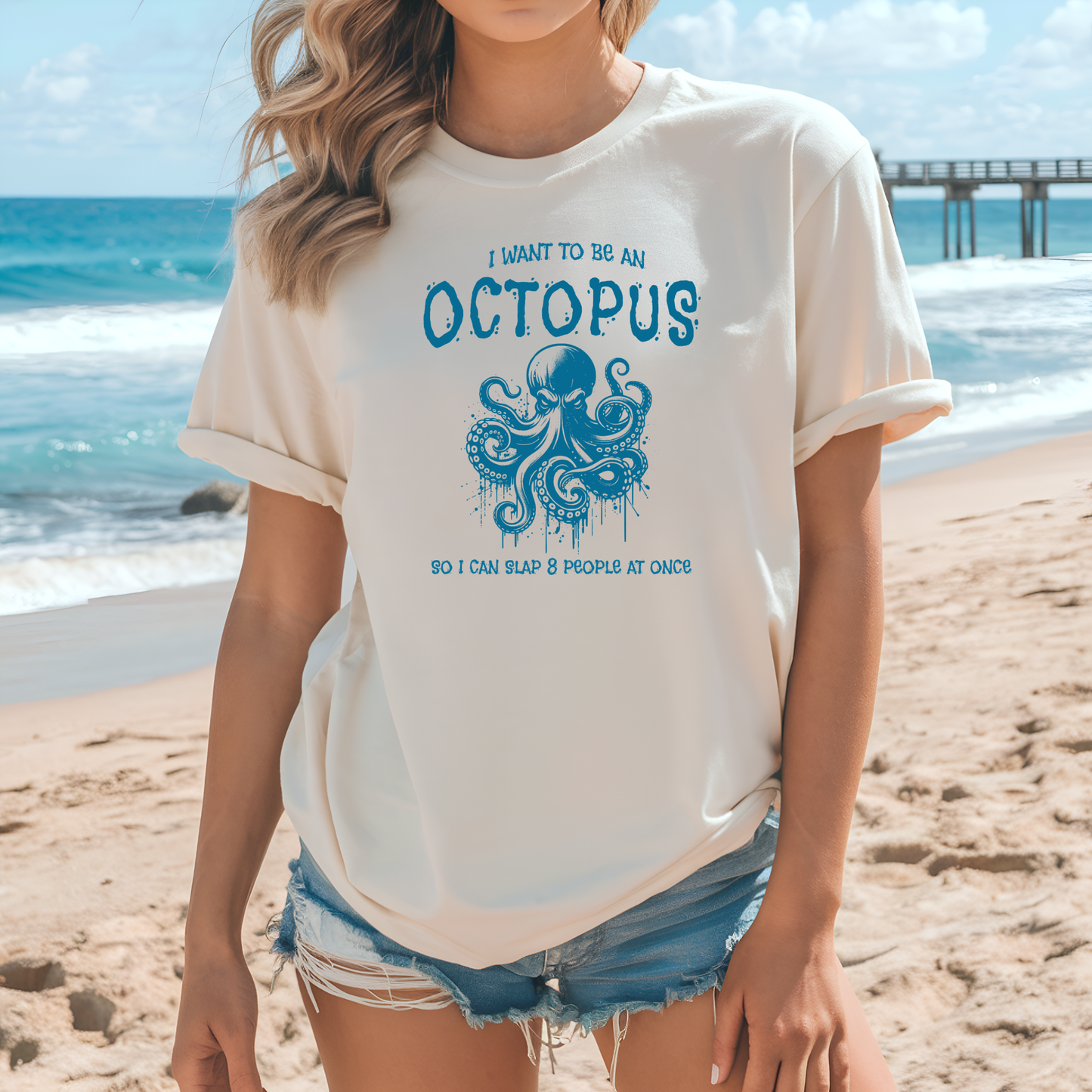 Bella Canvas 3001 "I Want To Be An Octopus So I Can Slap 8 People At Once" t shirt with an angry octopus one color graphic. Picture of a girl standing on the beach wearing a t shirt.