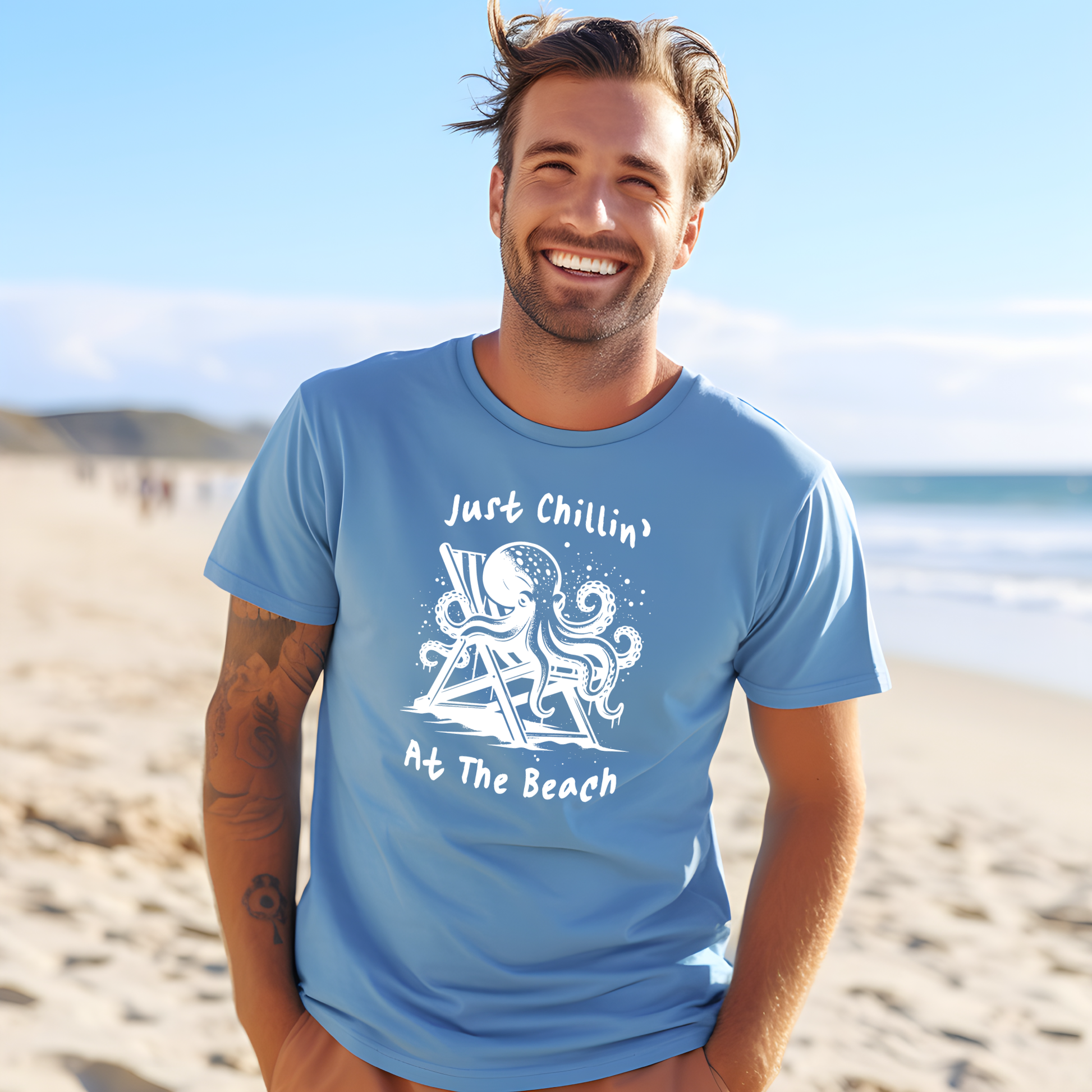 Bella Canvas 3001 "Just Chillin' At The Beach" t shirt with an octopus lounging in a beach chair in a one color graphic. Picture of a man standing on the beach wearing a t shirt.