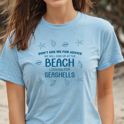 Person wearing a light blue t-shirt with beach-themed text and graphics.