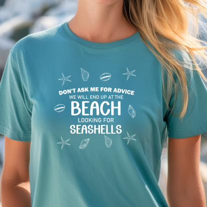 Person wearing a turquoise t-shirt with beach-themed text and graphics.