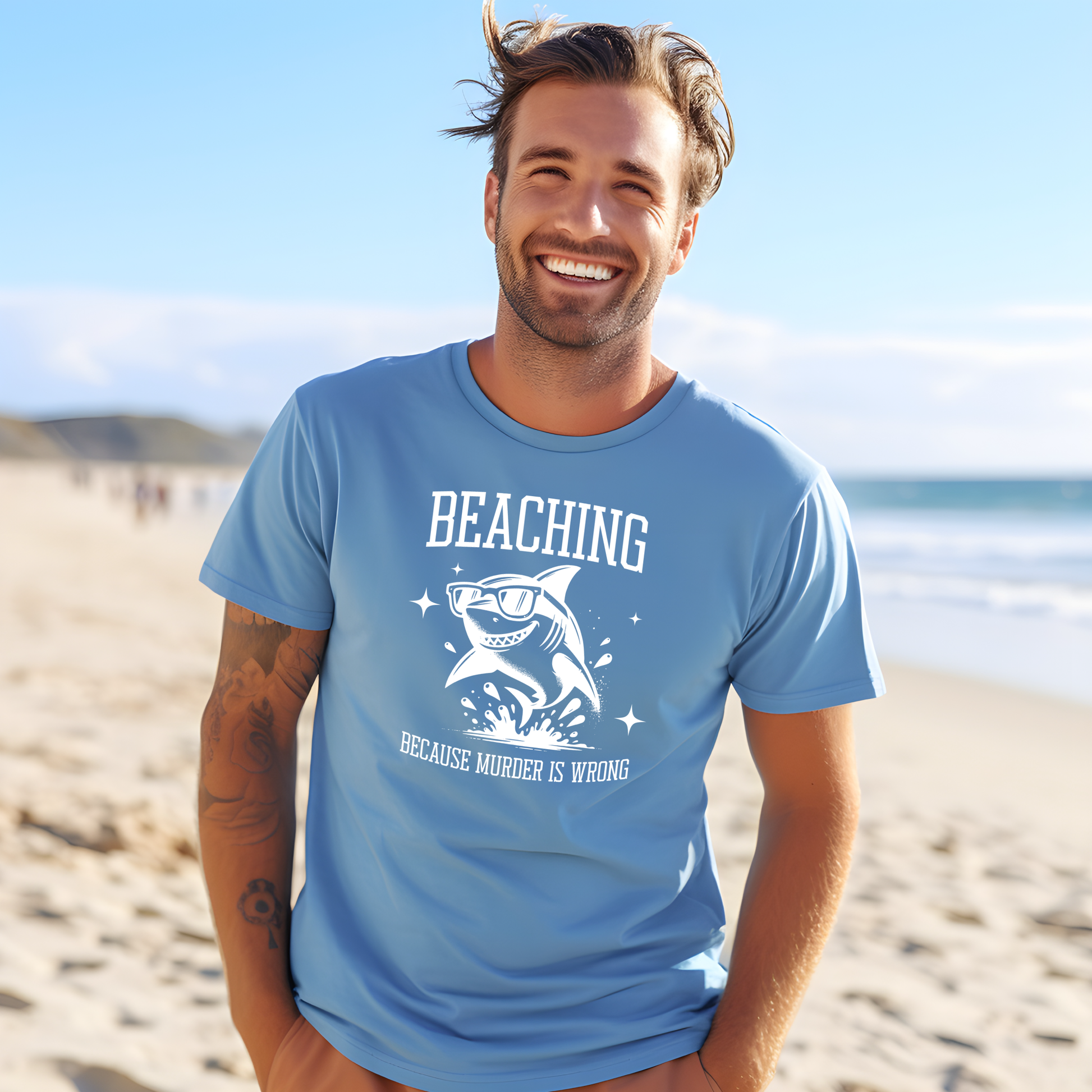 Bella Canvas 3001 Beaching Because Murder Is Wrong  T Shirt with Funny Shark with Sunglasses splashing in water in one color graphic. Picture of a man standing on the beach wearing a t shirt.