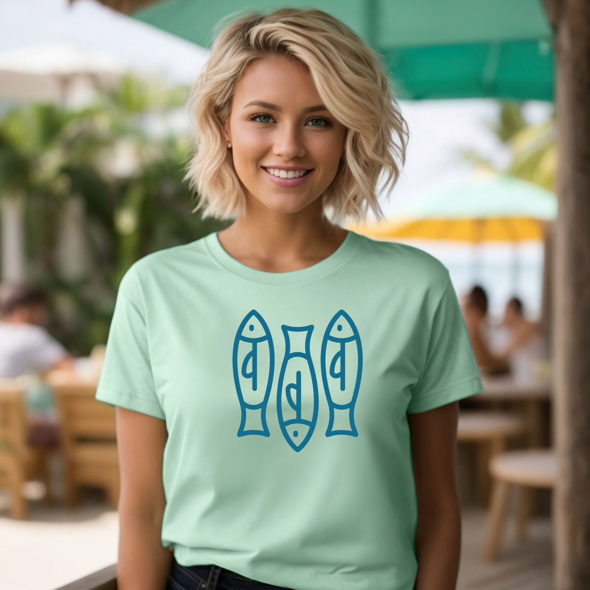 Bella canvas t shirt of a monoline art of  three sardines in one color graphic. Picture of a girl standing in a beach bar wearing a t shirt.