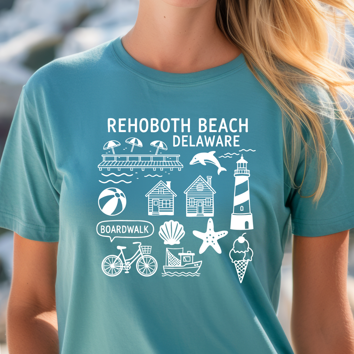 Person wearing a  turquoise t-shirt with Rehoboth Beach, Delaware graphics.