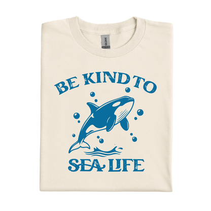 natural t-shirt with blue whale graphic and 'Be Kind to Sea Life' text on a white background
