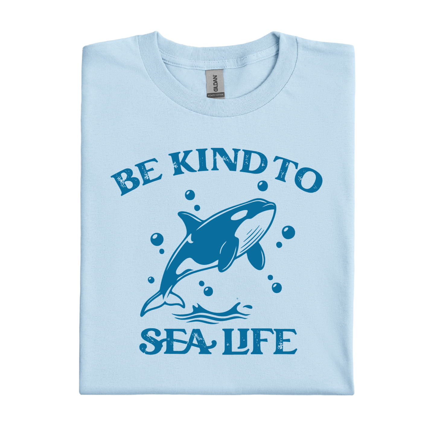 Light blue t-shirt with a whale graphic and text 'Be Kind to Sea Life' on a white background