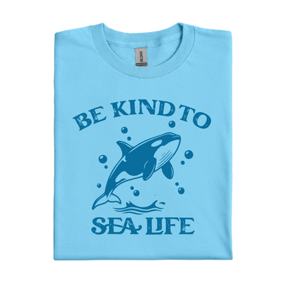 sky blue t-shirt with a whale graphic and text 'Be Kind to Sea Life' on a white background