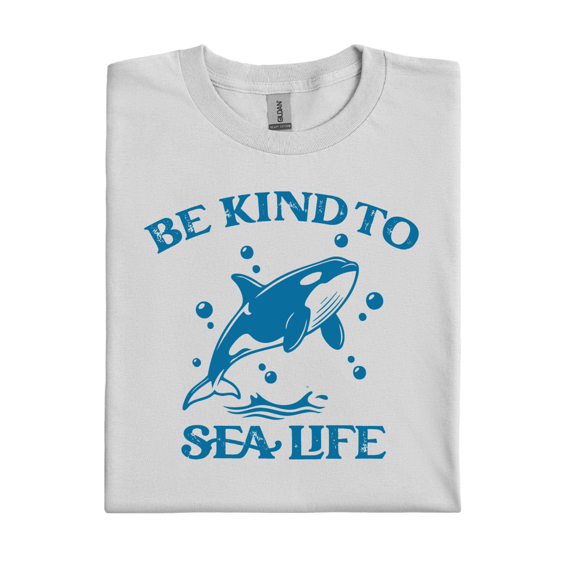 Folded t-shirt with a blue whale graphic and 'Be Kind to Sea Life' text on a white background
